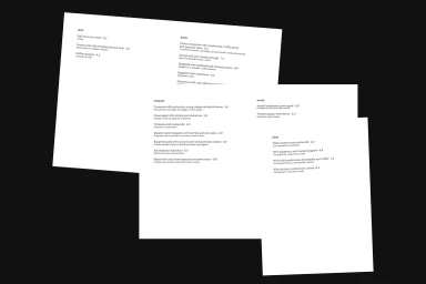 Three overlapping white restaurant menu pages featuring black typography against a dark background.