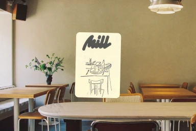 Illustrated card featuring Mill logo and dining sketch centered over a warm restaurant interior with wooden tables