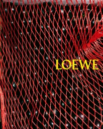 Close up of dark produce inside a red mesh produce bag with the word LOEWE in yellow text