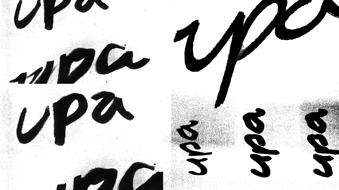 Abstract image of the text 'upa' in different sizes and orientations, rendered in black ink against a white background, creating a stark contrast.