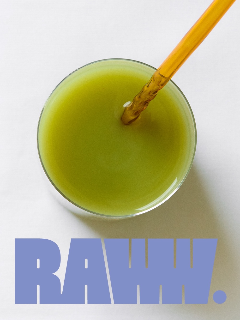 Overhead shot of a glass filled with a green beverage, featuring a brown straw and the word 'RAWH' in blue capital letters below.