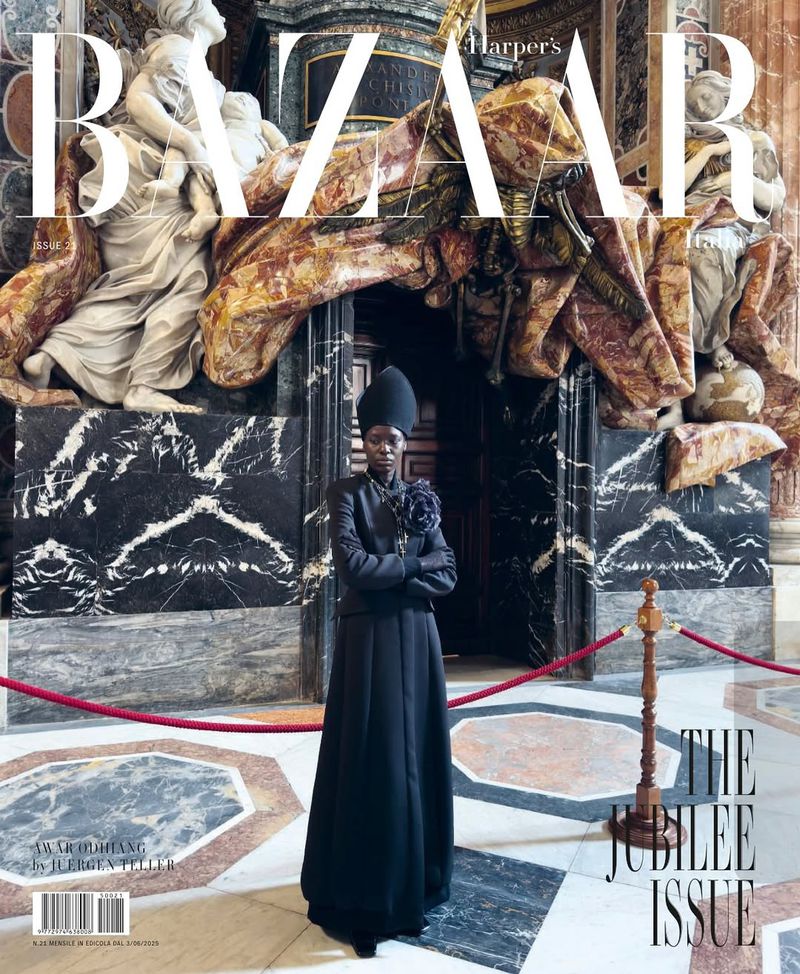 Harper's Bazaar cover featuring a Black woman in an elegant black outfit posing inside an ornate marble building with sculpture.