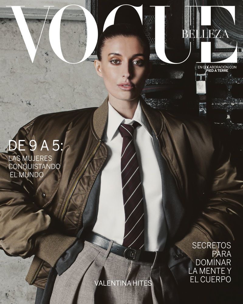 Vogue magazine cover featuring a stylish woman with a bomber jacket, tie, and high-waisted pants, standing against a neutral backdrop.