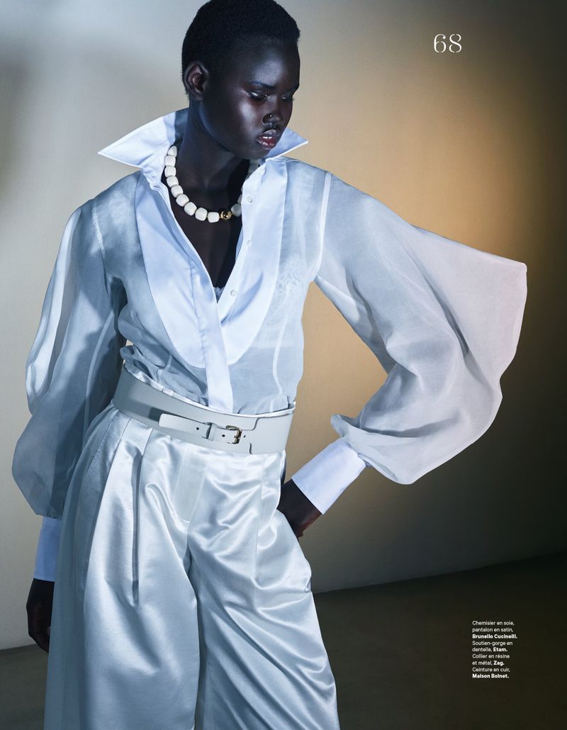 Model Nyakong Chan wearing a white silk blouse and light grey trousers for Les Echos Mise en lumiere editorial by Gianluca Fontana