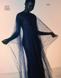 Black model Nyakong Chan wearing a sparkling dark blue sheer cape dress for a Les Echos fashion editorial by Gianluca Fontana.