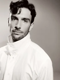 Portrait of athlete Lorenzo Musetti wearing a white collared shirt against a grey background for Esquire Australia cover.