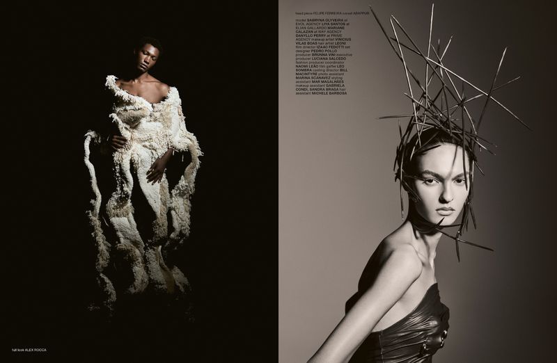 Fashion editorial shot featuring two women; one is wearing a large, textured white dress, and the other is wearing a black dress and headpiece.