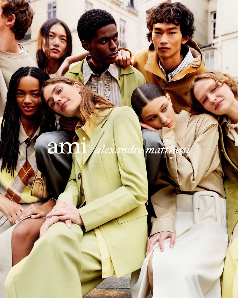 Group of diverse fashion models posing together outdoors for the Ami SS 2026 campaign photographed by Anthony Seklaoui.