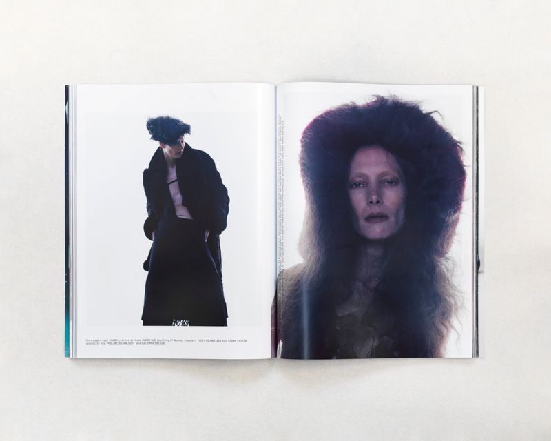 Open magazine spread featuring two fashion shots: one of a woman in a dark coat, the other a close-up of a woman in fur.