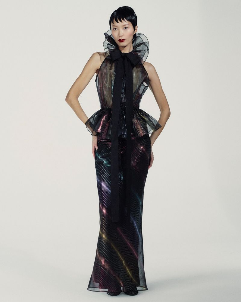Elegant Asian female model in halter gown with oversized collar and flared skirt in a studio setting showcasing high fashion.