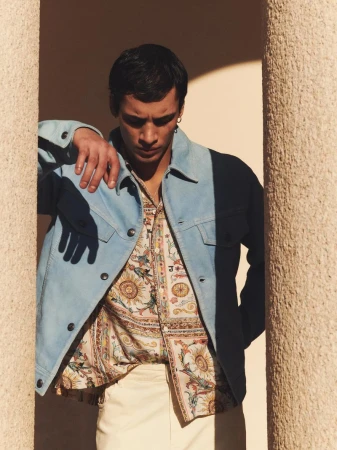 Model Mase Somanlall in a light blue jacket leaning between columns for Just Cavalli S/S 26 by Alessio Albi