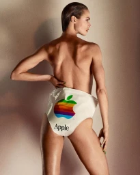 Model Birgit Kos wearing white plastic wrap featuring a vintage Apple logo for Middle Plane Magazine, shot by Mark Kean.