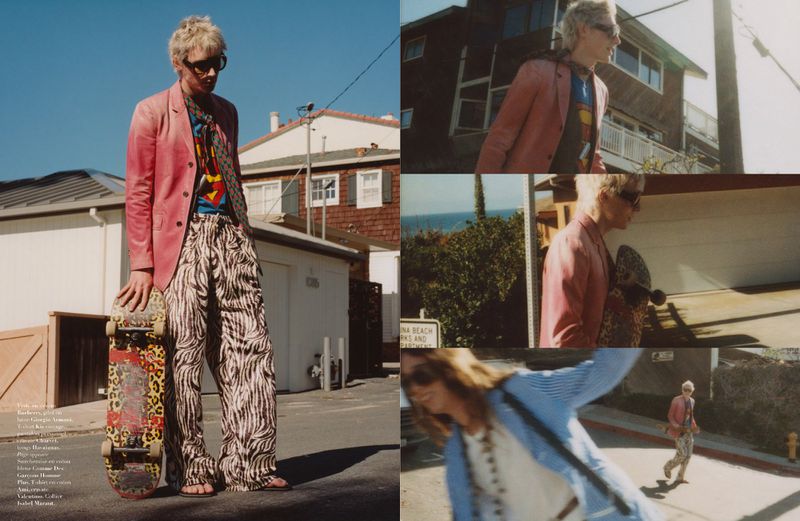 Model Buster Jaeger holding a skateboard on a suburban street for Harper's Bazaar France Homme.