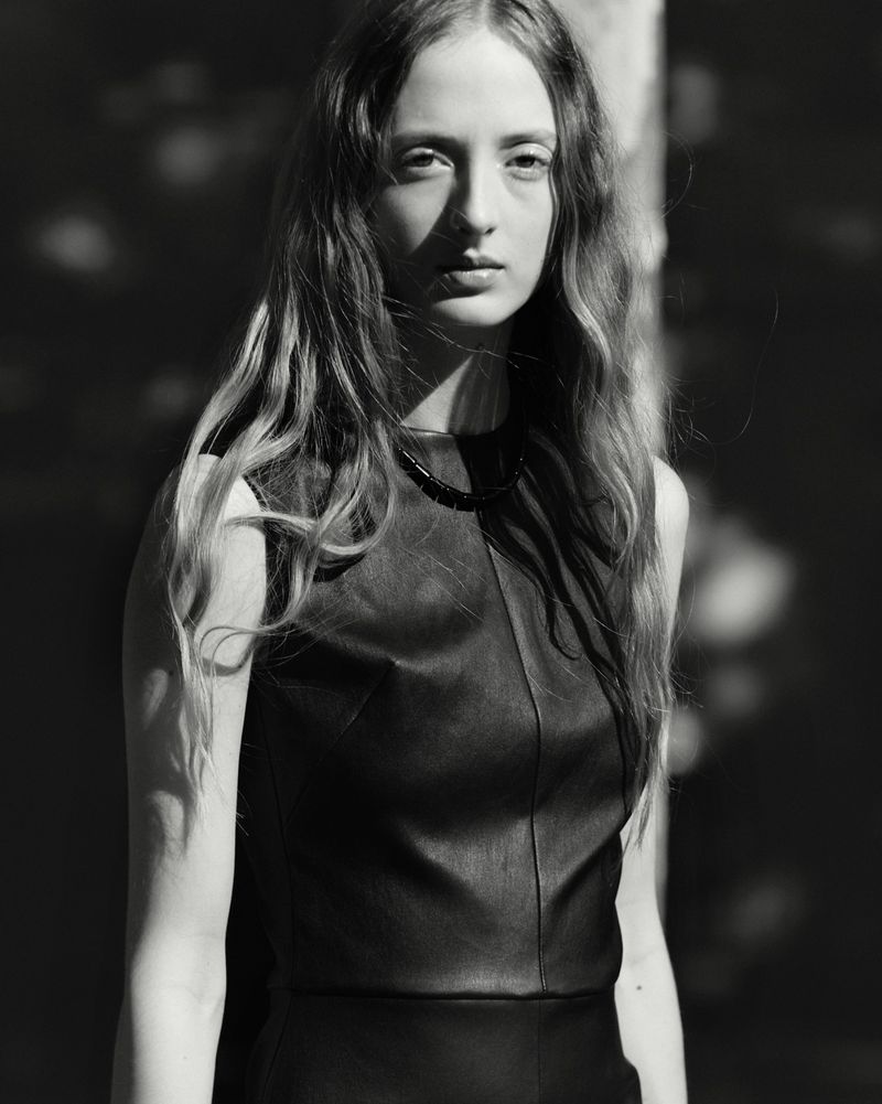 Monochrome portrait of a female model with long hair wearing a dark sleeveless top for Stouls Fall Winter 2026