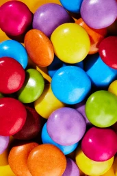 Close-up macro shot of colourful candy coated chocolate pieces filling the frame