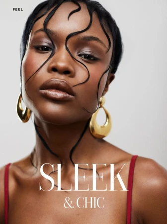 Close-up of an African American female model with sleek, wet-look hair, gold earrings, and soft lighting against a clean studio backdrop.