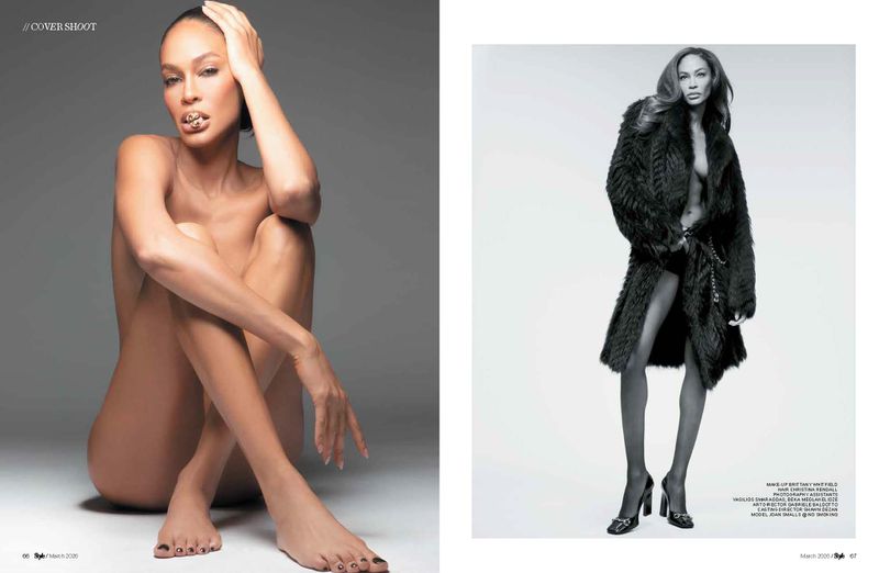 Black and white studio shot of a woman in a fur coat and another nude seated, striking a pose with hand on head.