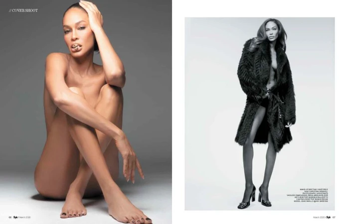 Black and white studio shot of a woman in a fur coat and another nude seated, striking a pose with hand on head.