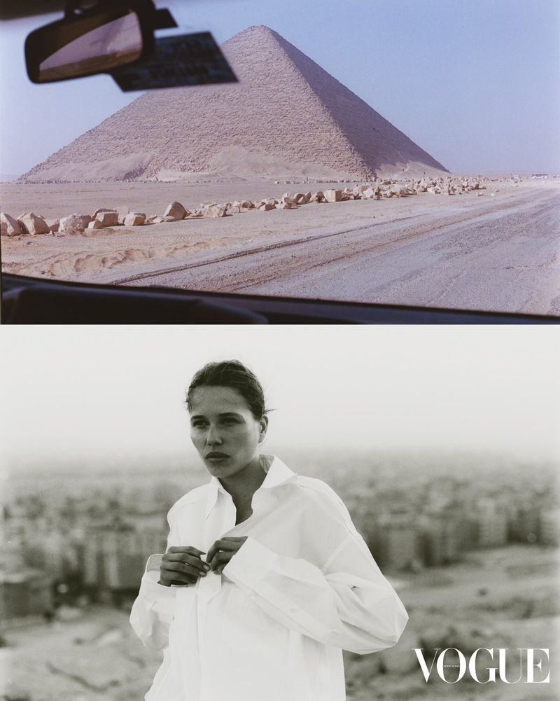 Fashion editorial with a woman in a white shirt in front of an urban background and the Great Pyramid of Giza viewed from inside a car.