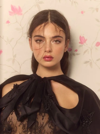 Deva Cassel in a black lace top against a patterned floral wallpaper background for Harper's Bazaar Turkey