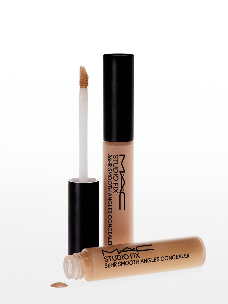 Studio shot of two MAC Studio Fix concealers, one with applicator, against white background. Beauty product photography.