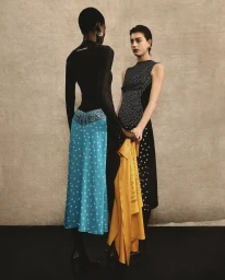 Two female models posing together against a textured neutral backdrop for Marine Serre Fall 2026 fashion campaign