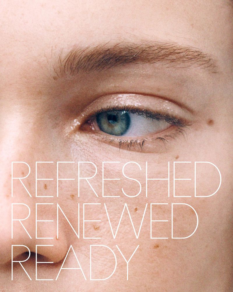 Extreme close-up on a model's face showcasing smooth skin, freckles, and a green eye, with the words 'Refreshed Renewed Ready' overlaid.