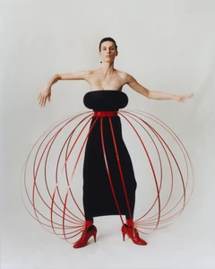 Model Marte Mei van Haaster in a structured black dress framed by red hoops for M Le magazine du Monde