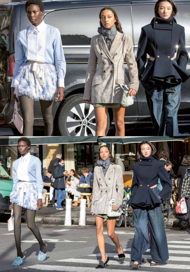 Three fashion models pose outdoors on a pedestrian crossing wearing stylish outfits, including a light-blue skirt and blazer.