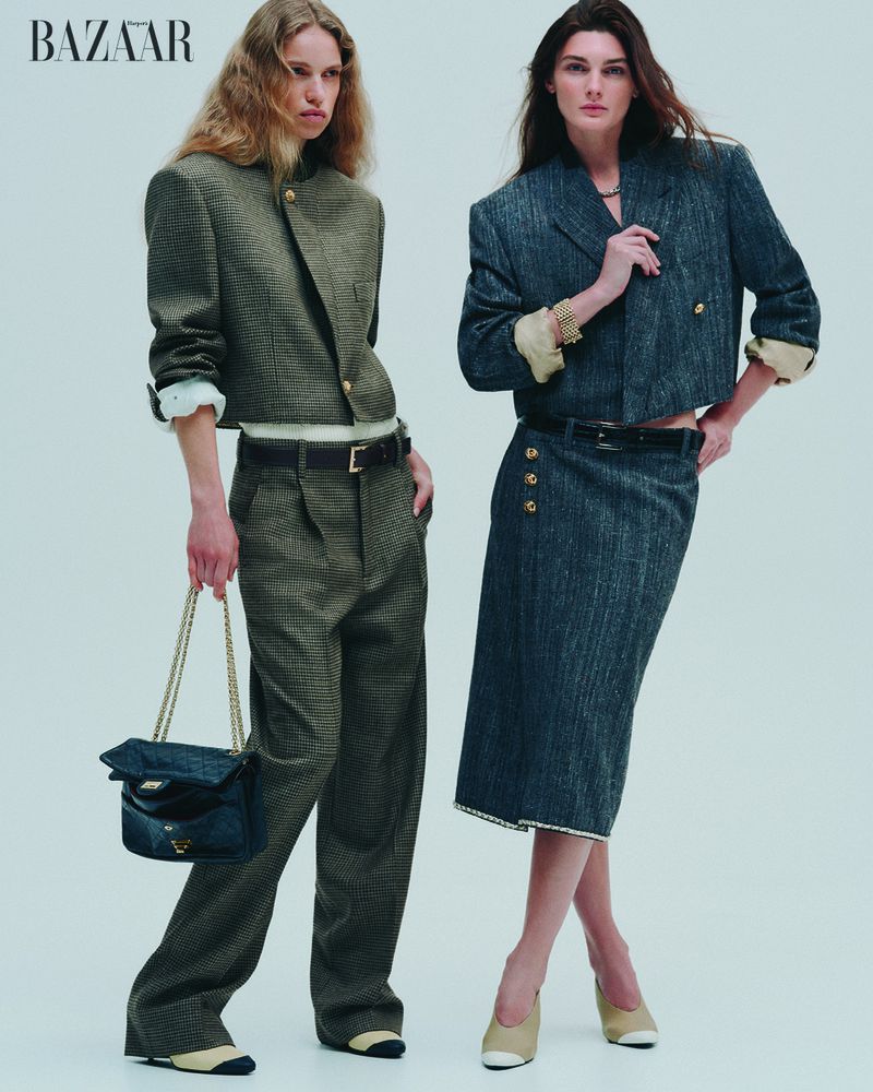 Two fashion models showcase tweed skirt and pants suit outfits in a studio shot for Bazaar, embodying high-end style and design.