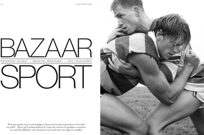 Two male athletes in close physical contact on a field, vintage-style rugby or sports scene, black and white aesthetic, athletic wear.