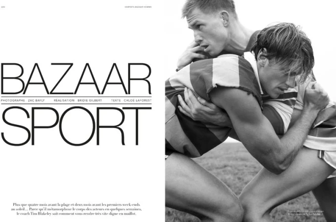 Two male athletes in close physical contact on a field, vintage-style rugby or sports scene, black and white aesthetic, athletic wear.