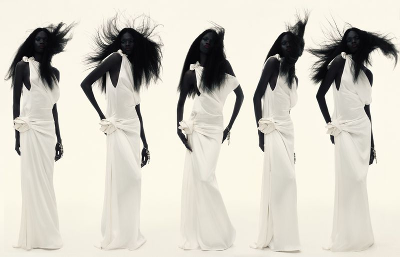 Multiple images of a Black female fashion model wearing a long, white gown against a white background. Studio lighting.