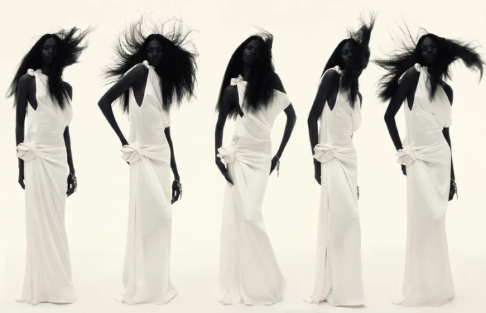 Multiple images of a Black female fashion model wearing a long, white gown against a white background. Studio lighting.