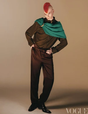 Model with red mohawk wearing brown shirt and green drape for Vogue China Men