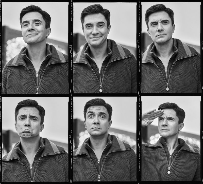 Black and white photo booth style portrait of a smiling adult male wearing a zip up sweater, in six different close up shots.