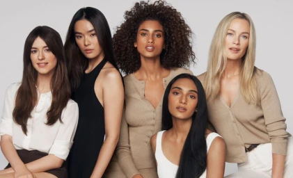 Group of six diverse female models and actors posed together against a neutral studio background for Estee Lauder Double Wear.