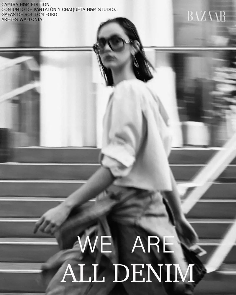 Black and white editorial fashion image of a model wearing dark sunglasses walking down outdoor stone steps for Harper's Bazaar Ecuador.