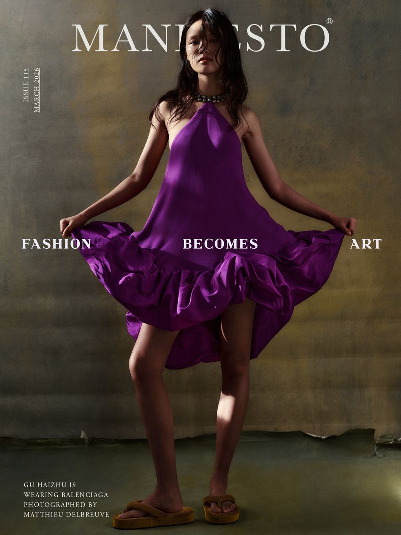 Fashion editorial cover of Manifesto Magazine featuring a slender woman in a purple dress and tan platform sandals, posing in a photo studio.