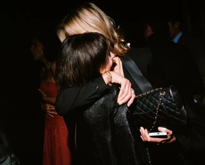 Two women embracing at an evening event, photographed by Ewen Spencer for British Vogue BAFTAs Portfolio 2026.