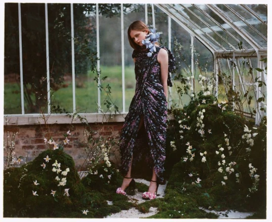 Model Ava Shipp in a floral gown inside a greenhouse for Vogue China, photographed by Javier Castán.
