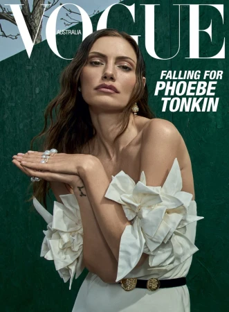 Vogue Australia cover featuring Phoebe Tonkin wearing a white dress with floral accents against a green backdrop, elegant jewelry.
