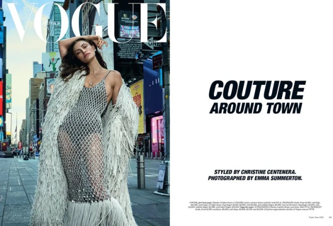 Vogue Australia cover featuring a model wearing a silver dress and white fringe coat on a city street with billboards in background.