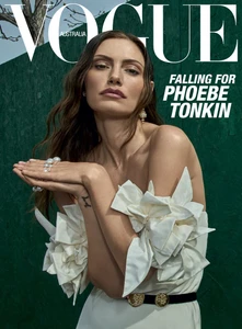 Phoebe Tonkin wearing a white dress with sculptural bows against a green textured background for Vogue Australia