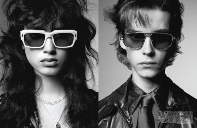 Black and white portrait of a stylish woman with wavy hair and white sunglasses, and a man with tinted sunglasses and a leather jacket.