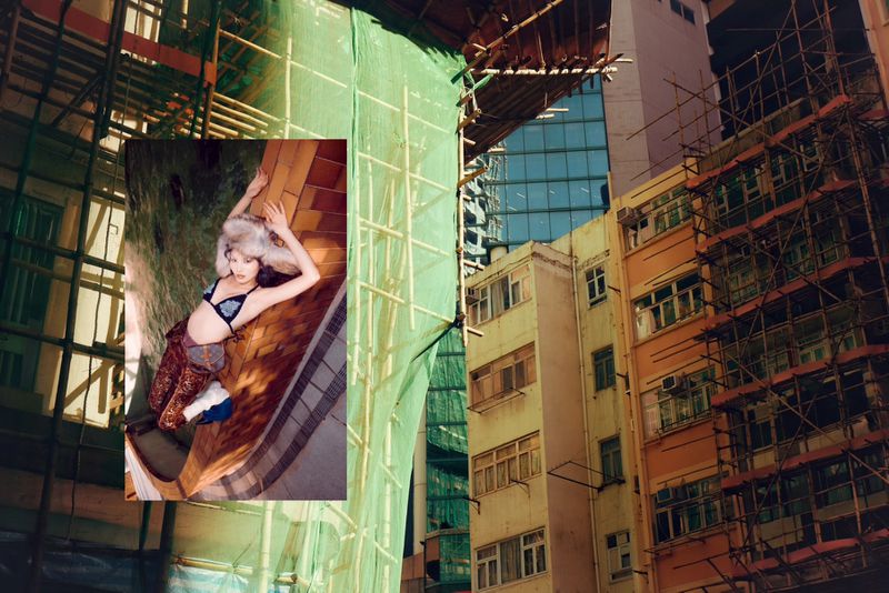 Fashion shot of a woman lying down with urban buildings and scaffolding in the background, overlaid with a green tarp.