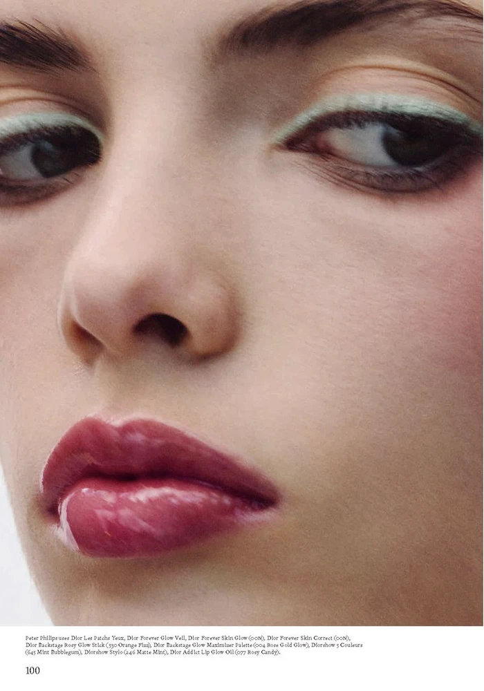 Close-up beauty portrait of a model featuring pastel green eyeliner and glossy mauve lips for Dior Beauty.