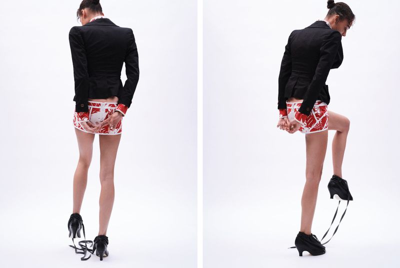 Two views of a slender adult female wearing a black blazer, patterned mini skirt, and high heels with trailing ribbons against a white background.