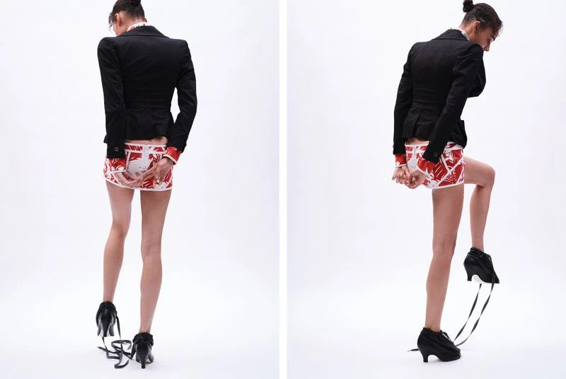 Two views of a slender adult female wearing a black blazer, patterned mini skirt, and high heels with trailing ribbons against a white background.