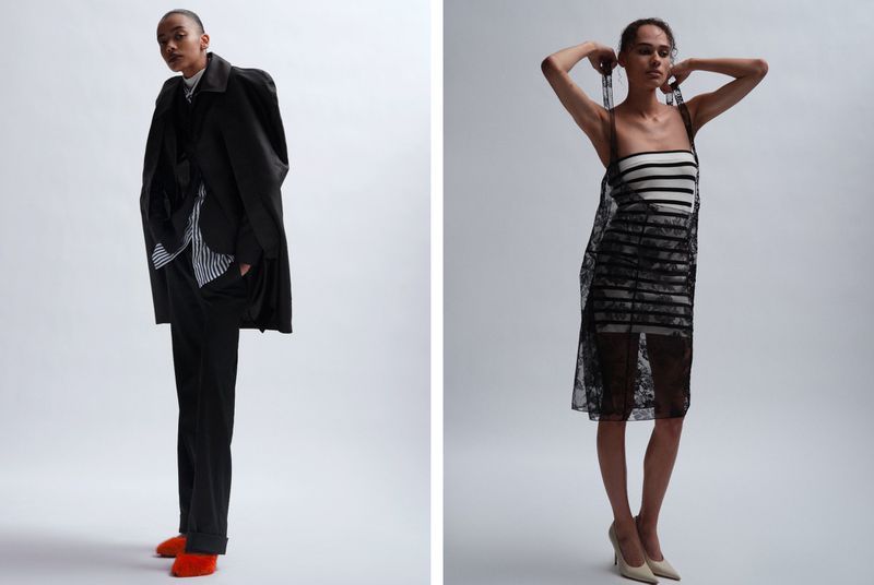 Two women in a fashion editorial: one wears a black coat and pants with red shoes, the other, a striped dress with a lace overlay.